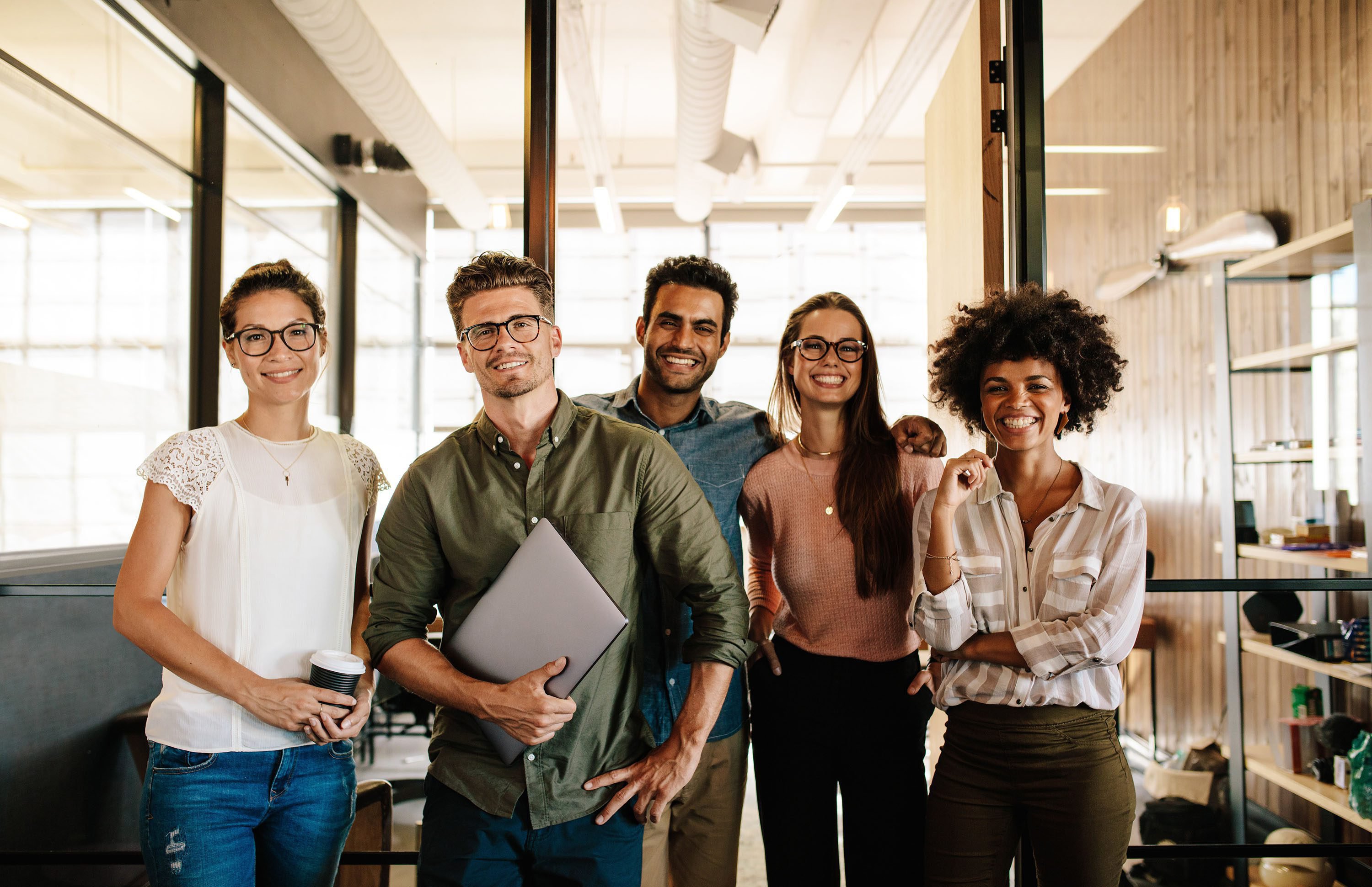 Team of people smiling at work.